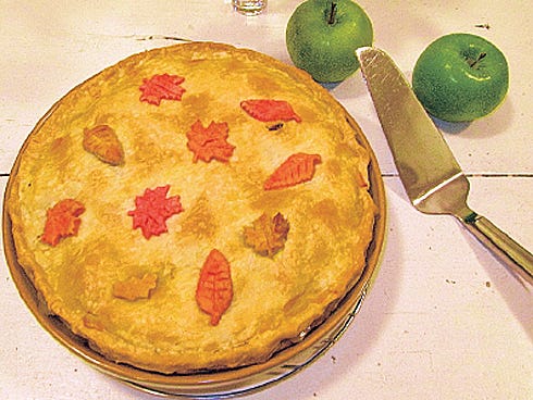 Transform a plain apple pie into an autumn apple pie by adding leaves of colored piecrust dough on top.