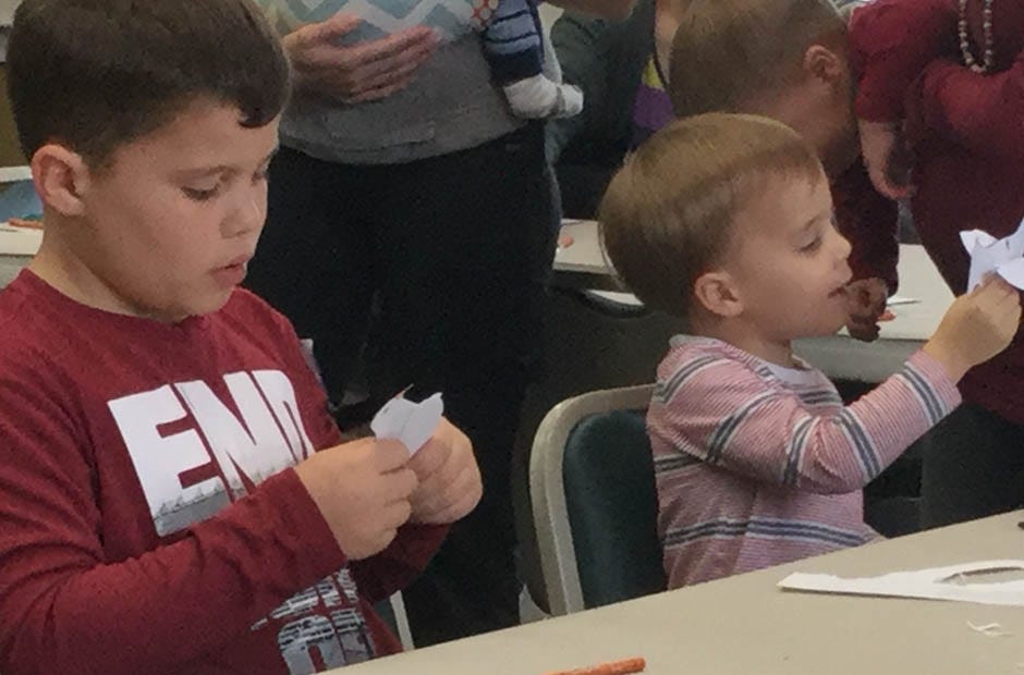 Crestview residents Josiah Sandler, 8, and Jeremiah Sandler, 3, make doves after class Jan. 10 at the Crestview Public Library. Special to the News Bulletin