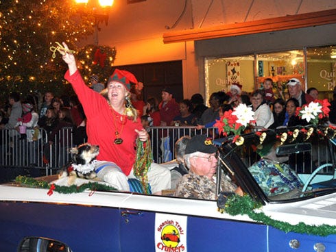 A participant in the 2010 Crestview Christmas parade greets the crowd.