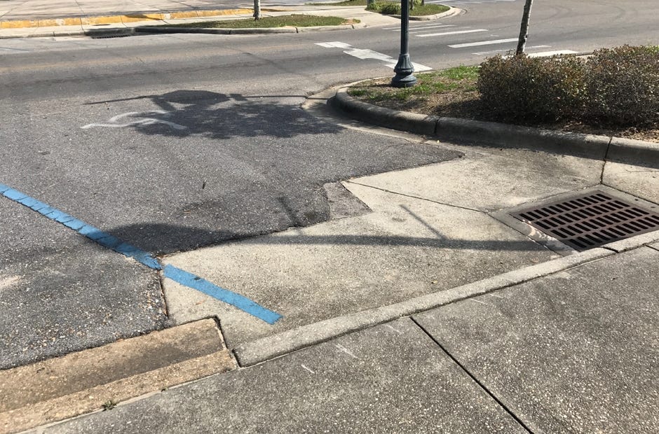 This disabled spot on Main Street feeds into a sewer vent. The nearest ramp requires individuals travel through traffic onto the crosswalk ramp. [MARK JUDSON/News Bulletin]