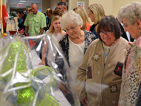 Attendees eye auction items on Monday during the sixth annual Exodos Ministry Dinner and Auction at Woodlawn Baptist Church. The event raised $15,000 to help men with chemical addictions.