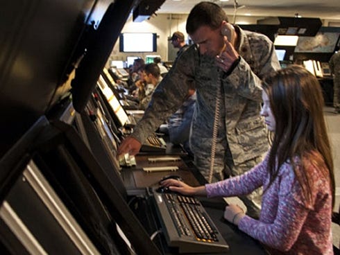 Crestview High School student Tiffany Berkely experiences what it's like to be an air traffic controller recently at the Eglin Range Control Facility. Her lesson, with Maj. Mark Oden, 96th Operations Support Squadron flight commander, is part of the 96th Test Wing Academy's Affirmative Employment Program, a base mentoring initiative.