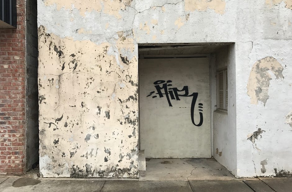 A vacant building on downtown's Main Street is tagged with spray paint. [MARK JUDSON/NEWS BULLETIN]