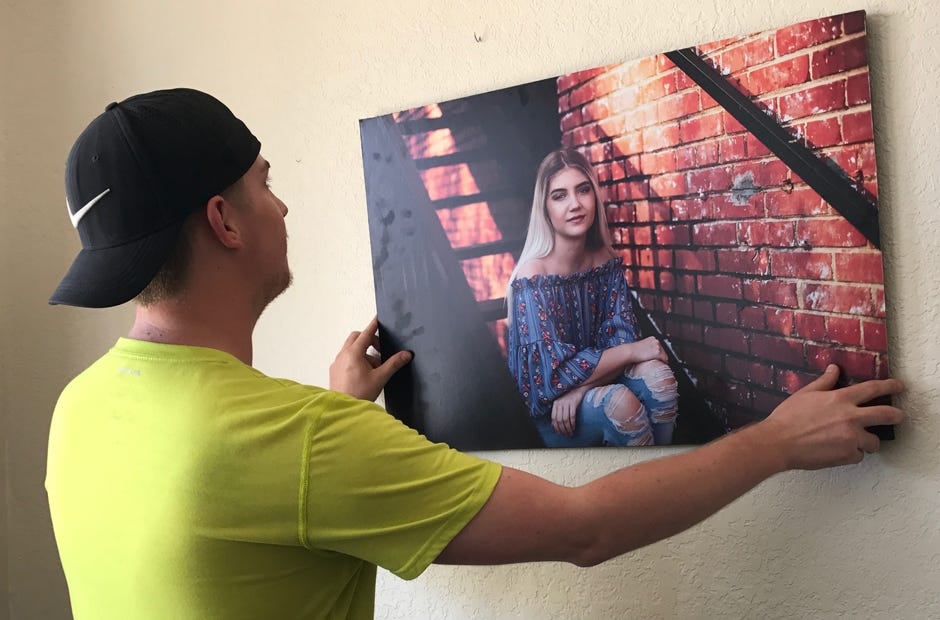 Photographer Dale Riley prepares pieces for the first monthly gallery night at Casbah Coffee. [MARK JUDSON/NEWS BULLETIN]