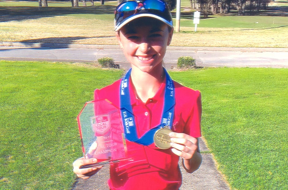 Gracie Grant of Crestview, 11, holds the Tour Champion award and blue ribbon she received as first-place winner of the Eglin golf tour that ended Feb. 12 on Eglin Air Force Base. [Special to the News Bulletin]