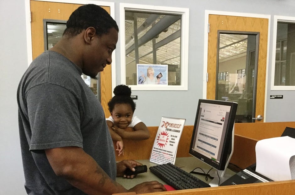 Jamelle Mayo, 3, watches as her dad, Jamel Mayo of Crestview, uses a scanner to upload documents to a website at the Crestview Public Library. 

Have a cute photo of your kids out and about? They could be our next The Bulletin Kid! Email a photo with your child's name, age, hometown and a description of the action to news@crestviewbulletin.com.