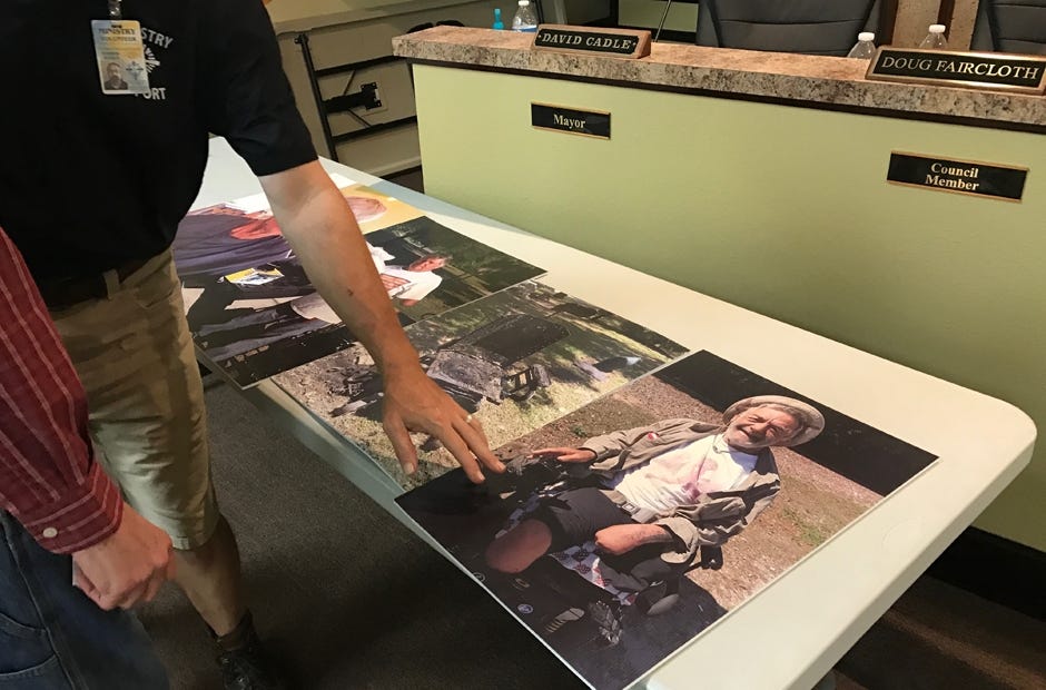 David Booher displays photos of homeless individuals he has worked with through church ministries. [MARK JUDSON/NEWS BULLETIN]