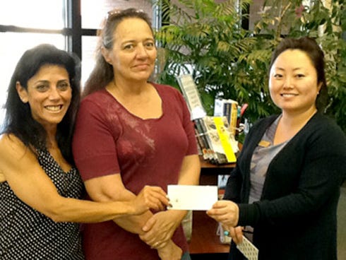 From left are Mary Deering, Dee's friend; Dawn Toth, Dee’s daughter and a Crestview resident; and Marie Garcia, assistant library director, accepting on behalf of Library Director Jean Lewis, who was in Tallahassee attending the Florida Library Directors conference.