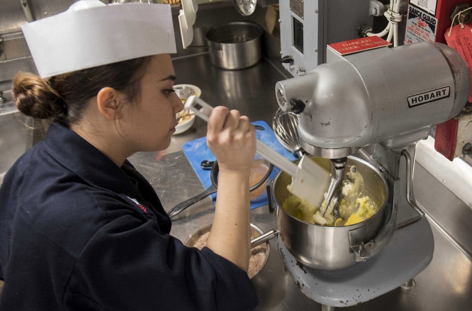 U.S. Navy Culinary Specialist 1st Class Ariel Coley of Crestview prepares brownie mix in the flag galley aboard amphibious assault ship USS Bonhomme Richard in the Philippine Sea. [Kyle Carlstrom | U.S. Navy]