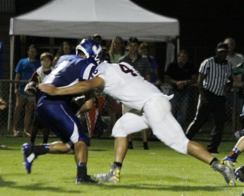 Baker middle linebacker Montae Barto delivers a big hit on Jay tailback Braden Cross throwing him for a loss to help preserve the win for Baker in Friday’s Kickoff Classic.