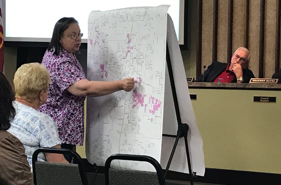 Growth Management Director Teresa Gaillard shows a map highlighting out-of-city locations that receive Crestview water and sewer services. [MARK JUDSON/NEWS BULLETIN]
