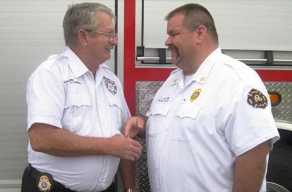 Mayor David Cadle named Deputy Fire Chief Tony Holland — right, with Almarante Fire Chief Charles Carroll —Crestview’s new fire chief. [File photo]