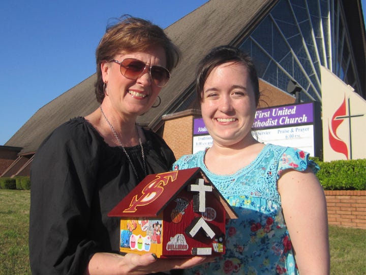Paul and Cecily Hinton and their children Jesse, Josh and Melissa, decorated their church bank "representing the whole family," said Cecily, shown with Melissa, 18. Among the artwork were motifs for Florida State University, the University of Central Florida, Auburn University and Crestview High School.