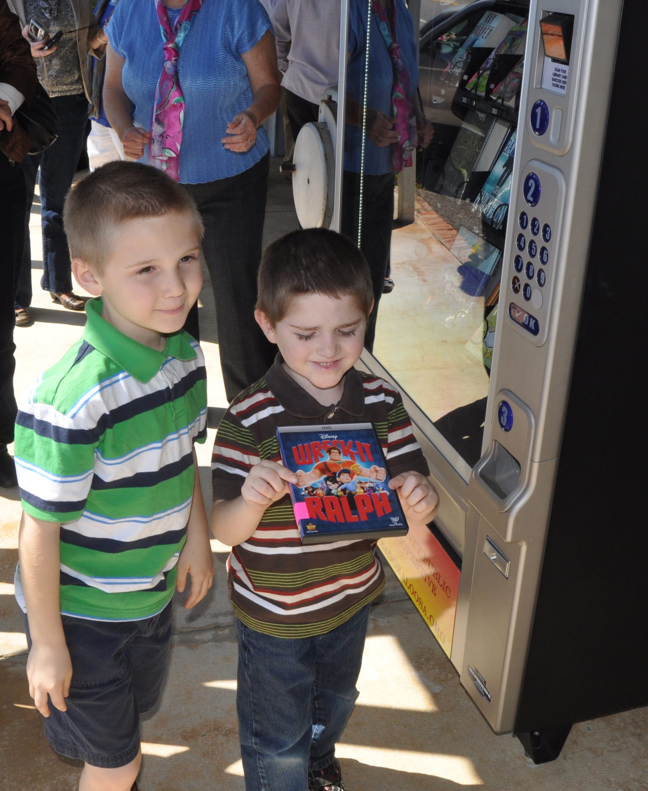 The Okaloosa County Library Cooperative’s Lending Machine at Baker Block Museum brings library resources to residents outside Crestview city limits. From left are Gabriel and Jacob Pilkington, who attended a ribbon cutting for the service on Friday.