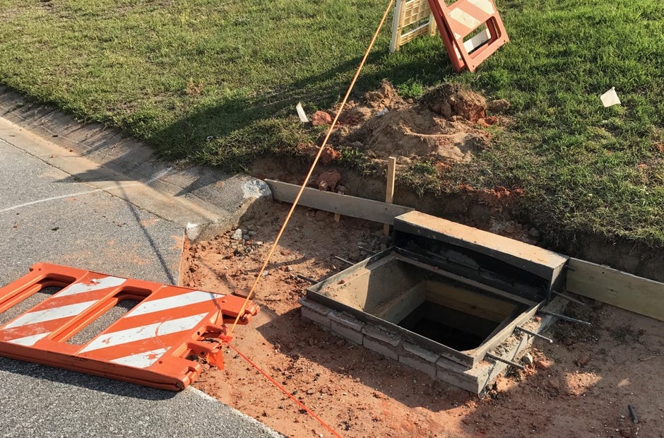 The storm drain on Raptor Drive was left open and barricaded with a single tape line and fallen signs.