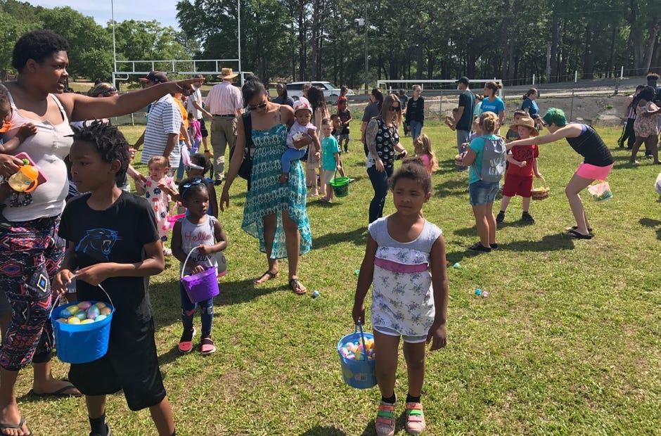 Filling one's bucket was only half the experience. Children then opened each of their collected plastic eggs to reveal what, if anything, was inside. [MARK JUDSON/NEWS BULLETIN]