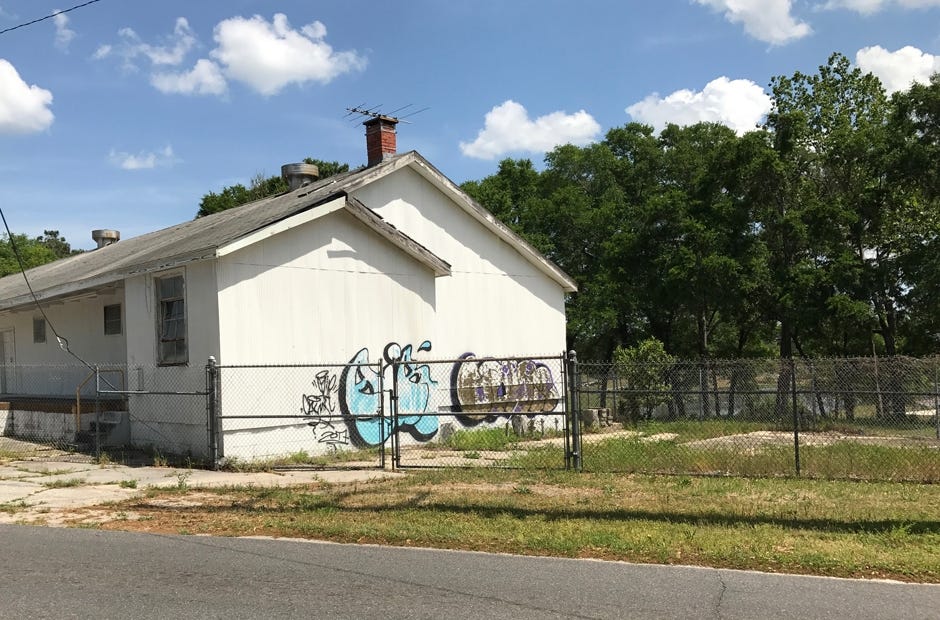 New plans for Crestview Junction call for demolishing this vacant property and convert it to a park, connecting with Twin Hills Park, seen in the background. [MARK JUDSON/NEWS BULLETIN]