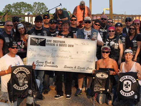 Iron Order Motorcycle Club of Crestview members present a $1,500 check to FamiliesFirst Network representative Mary Culbertson, center, following Saturday's second annual Poker Run at Split Oaks Saloon. Proceeds will help local needy foster families, event organizers said.