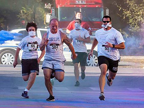 Runners pass through clouds of non-toxic powdered paint during last year's 5K Orphan Run, which raised nearly $6,000 for Lifepoint Church's orphan care projects. The event returns to the south Ferdon Boulevard church Dec. 7.