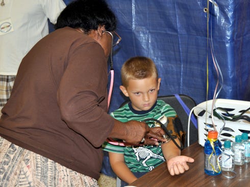 health
Mae R. Coleman checks a child’s blood pressure during last year's No Child Without Health Care Fair at Crestview High School. The annual event, which offers free children’s health screenings, returns to the same location on Saturday.