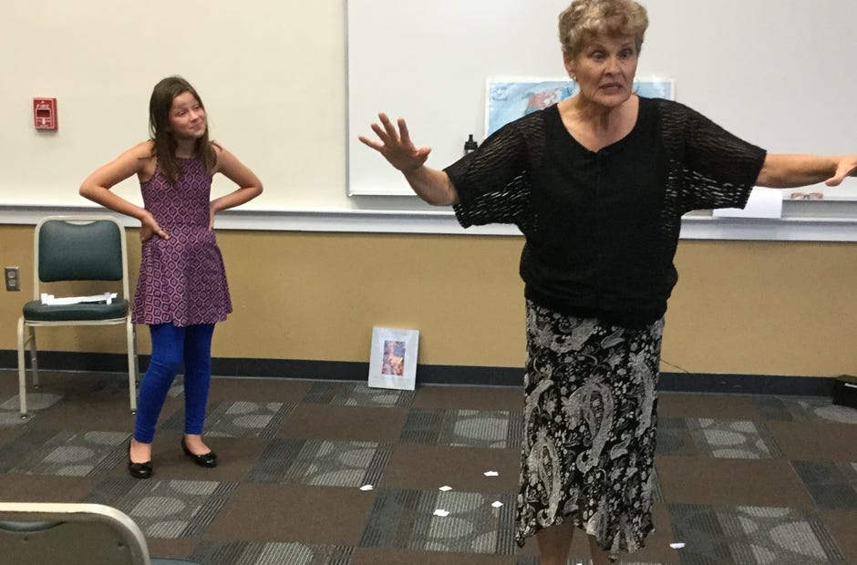 Kinsley Jones, 9, of Crestview, portrays one of the three billy goats gruff as guest storyteller Gail Nelson describes part of the story May 30 at the Crestview Public Library. [Special to the News Bulletin]