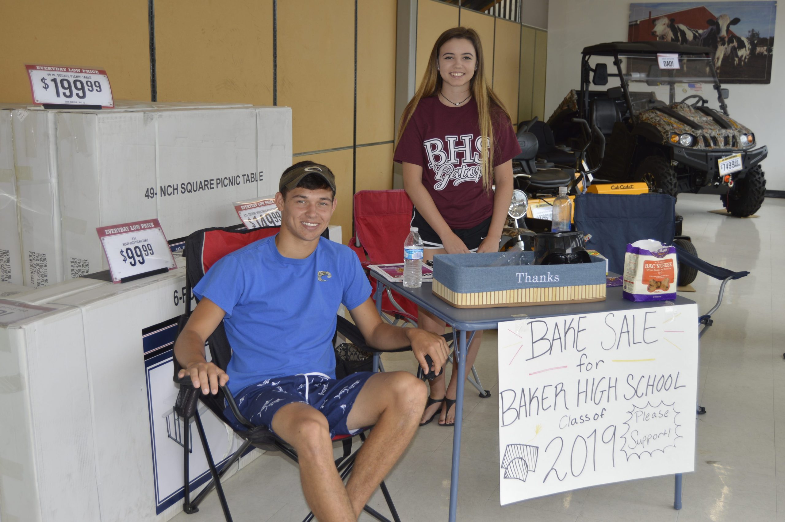 Payton Rockwell and Olivia Clendennin of Baker School set up a bake sale booth at the PAWS pet adoption event at Tractor Supply. Proceeds they collected will benefit the class of 2019 and help pay for dog treats for pets attending the event. [ALICIA ADAMS/NEWS BULLETIN]