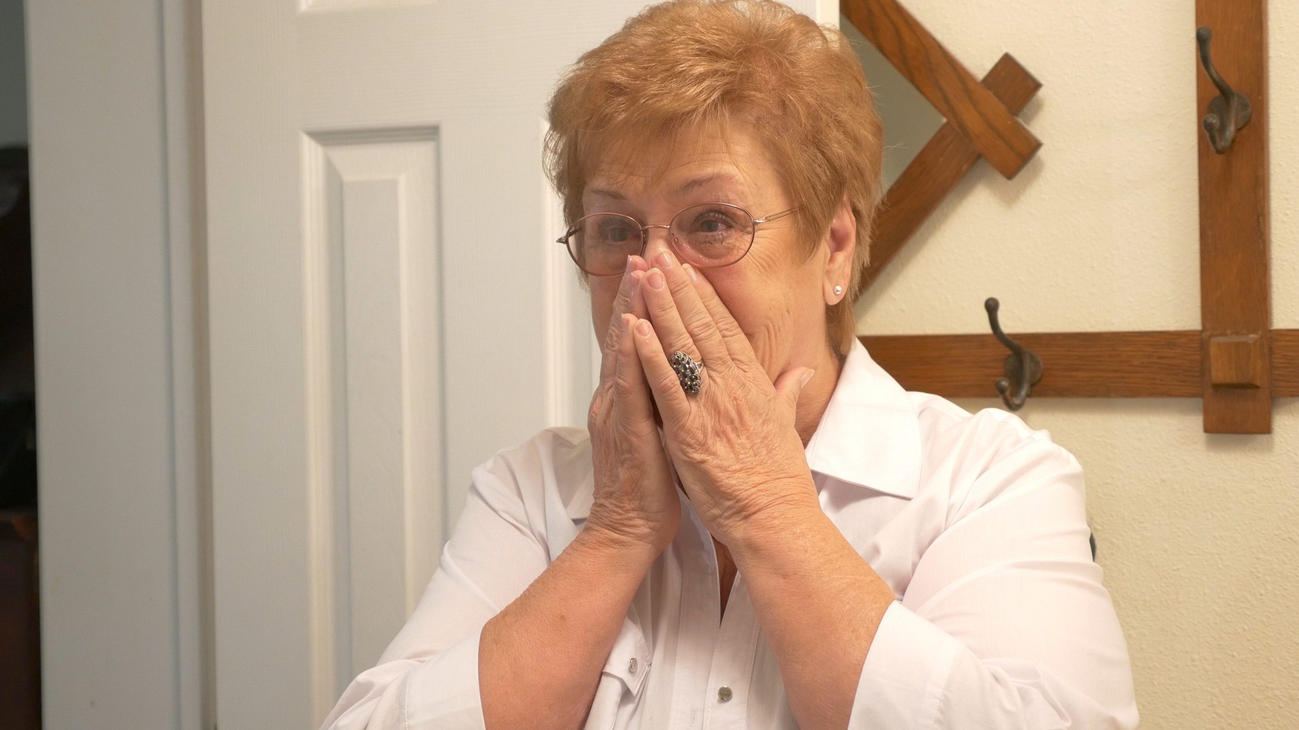 Shirley Perring reacts upon seeing the walk-in shower that Safe Step Walk-In Tub Co., installed as a surprise. [Special to the News Bulletin]