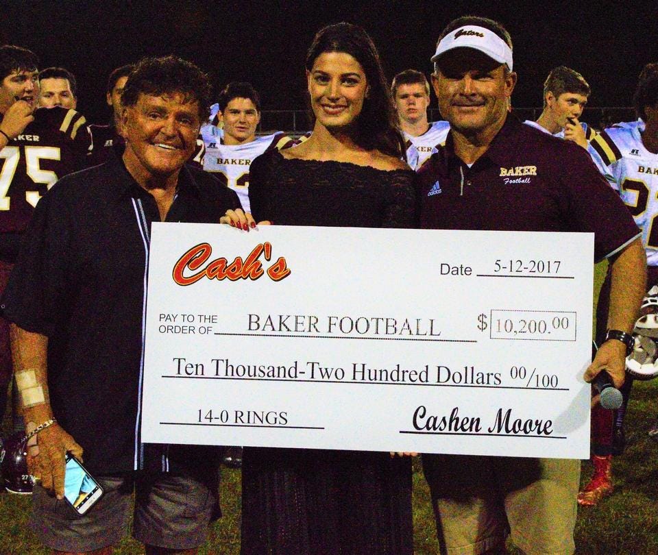 On May 12, Cash and Cashen Moore presented a check to the Baker Gators for $10,200 that paid for their 14-0 rings. [JOHNNY C. ALEXANDER | News Bulletin]