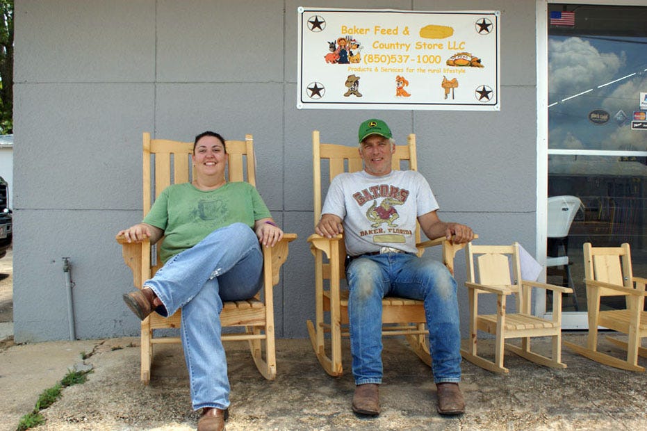 Baker Feed and Country Store manager Jennifer Augustine and owner Tony Happel relax in rocking chairs available for purchase. The store's grand opening is 8 a.m. to 2 p.m. July 9 at 5791 U.S. Highway 4. Handmade gifts, clothing, boots and specialty feeds are part of its inventory.