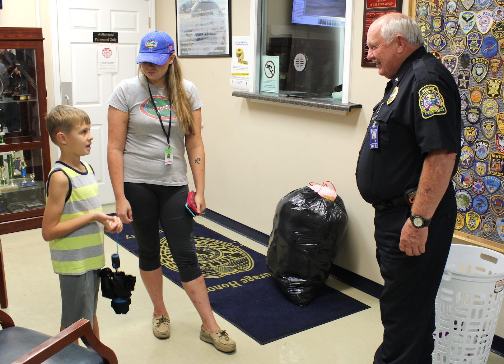 As his mom, Ashley Hinshaw, observes, Weston, 7, receives the gratitude of Crestview Deputy Police Chief Rick Brown for his donation of stuffed animals. The donation will be used to calm distraught children. [BRIAN HUGHES | Crestview Police Department]