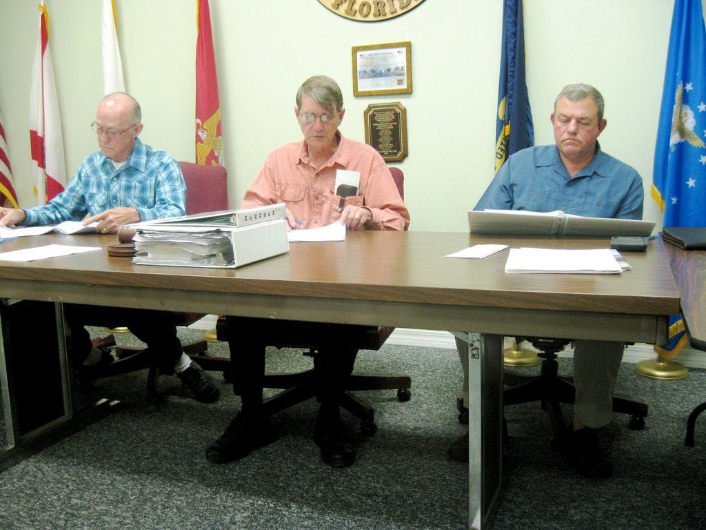 Laurel Hill City Council Chairman Larry Hendren, center, presents draft information about dissolving the city to the council, including Councilman Daniel lane, left, and Scott Moneypenny. Upon completion, the information will be shared with voters, who will ultimately decide if the city would remain an independent municipality or become part of Okaloosa County.