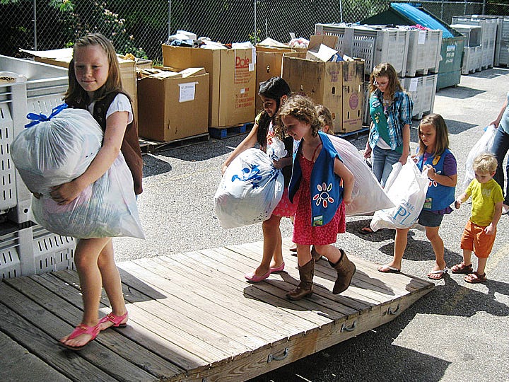 Led by Brownie Tessa Campbell, Troop 676 Girl Scouts, with their mothers and siblings, deliver collected clothing, blankets and toiletries donations to Waterfront Mission recently.