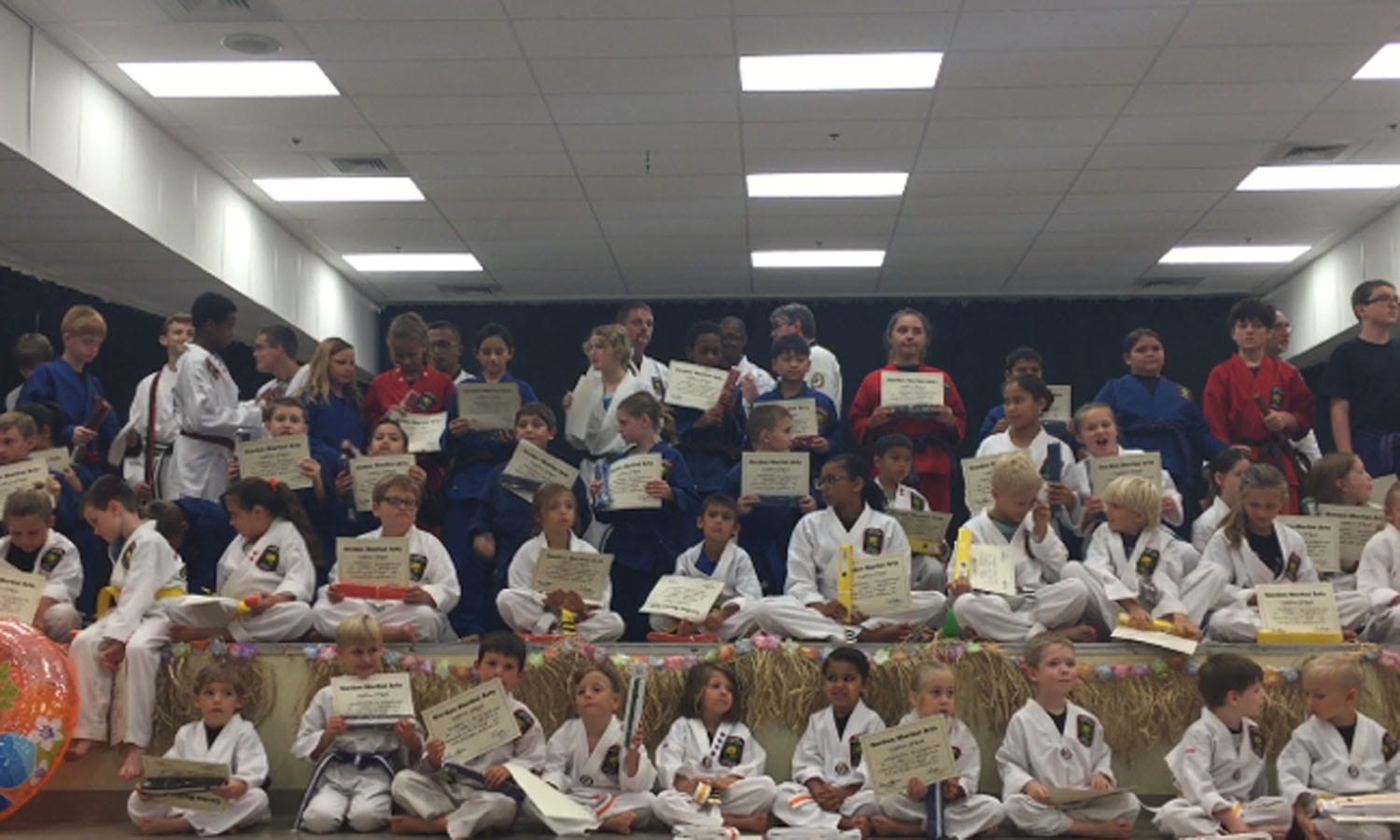 Children gather for their group photo after receiving certificates of accomplishment at the end of Gordon Martial Arts' promotional ceremony. [GENEVIEVE DINATALE | NEWS BULLETIN]