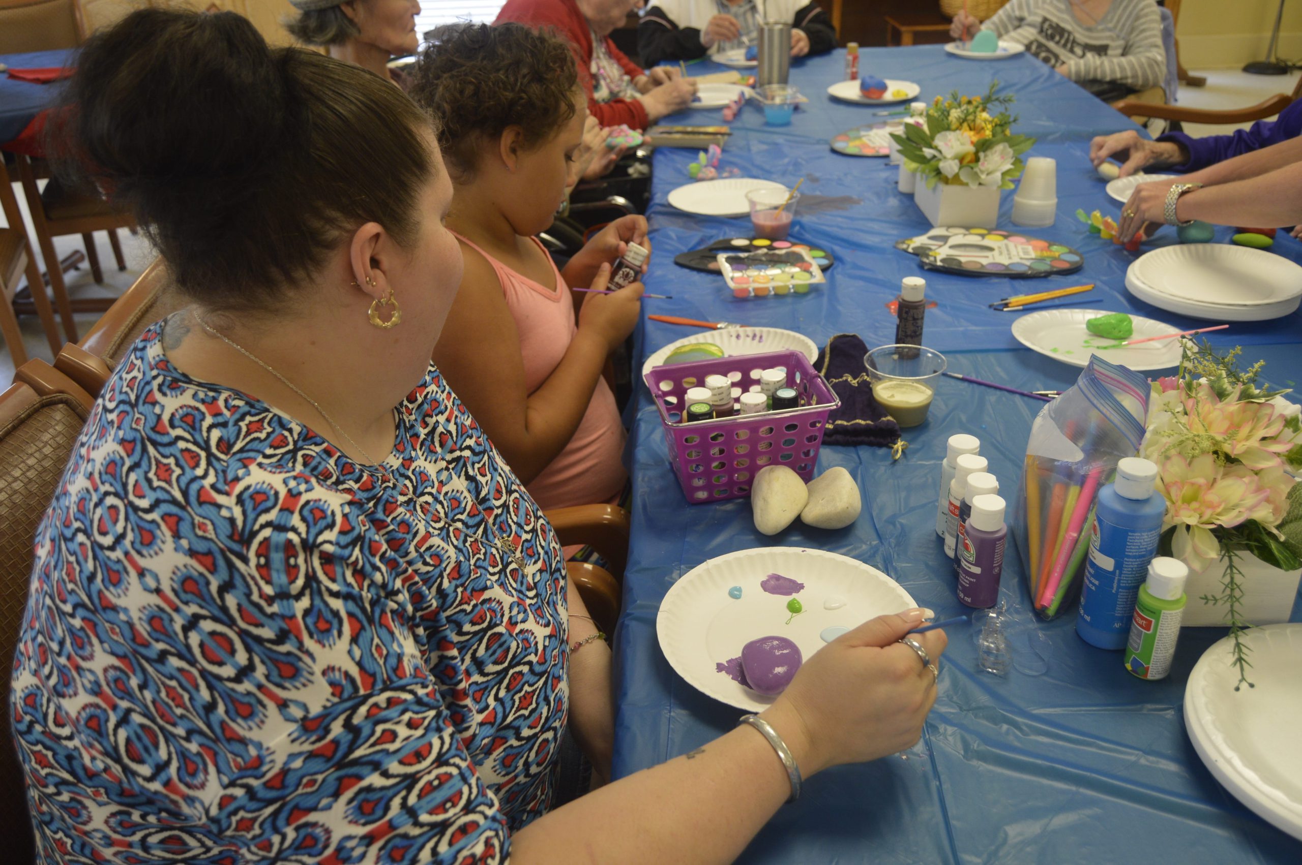 Casey and Makaylah Deshields paint rocks atCrestview Rehabilitation Center's rock painting event. [ALICIA ADAMS | News Bulletin]