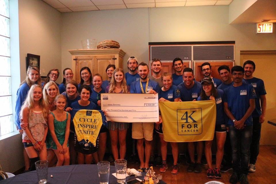 4k For Cancer riders present a high school student (sixth from right) in Chicago with a $2,500 scholarship to attend the University of Alabama. [Special to the News Bulletin]