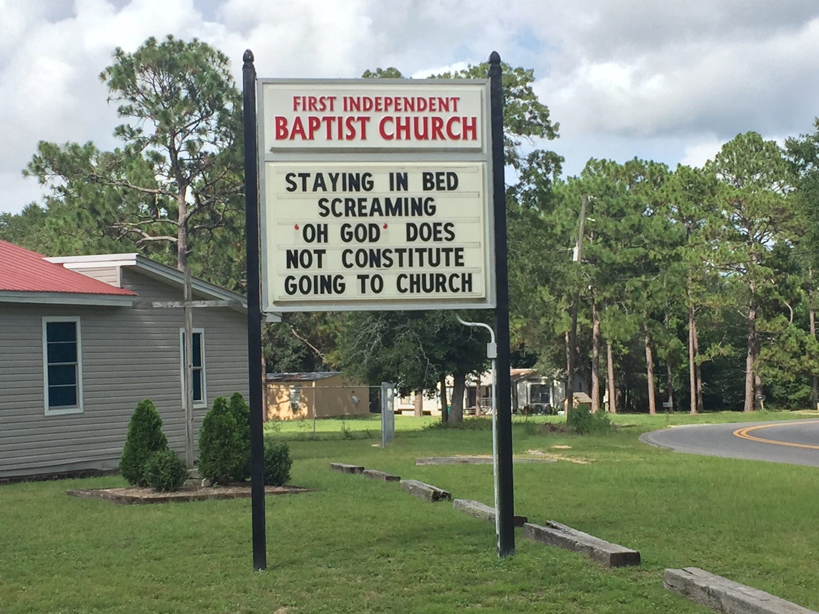 This sign outside First Independent Baptist Church says, "Staying in bed screaming 'Oh God' does not constitute going to church." Some residents question whether the sign has sexual overtones. [GENEVIEVE DiNATALE | NEWS BULLETIN]