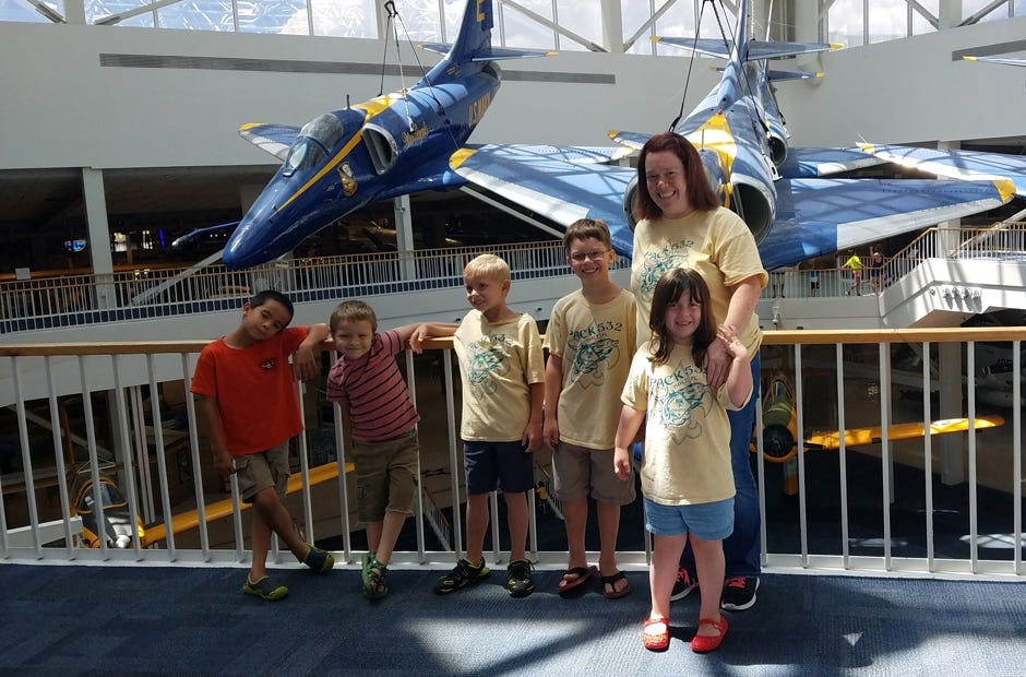 Nicholas Johnson, Tate Johnson, Adrian Cummings, Jacob Strom, Courtney Strom, and Ellie Strom of Holt Cub Scout Pack 532 stand in front of the Blue Angels display recently at the Armament Museum in Pensacola. [Special to the News Bulletin]