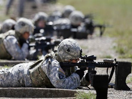 In this Sept. 18, 2012 file photo, female soldiers from 1st Brigade Combat Team, 101st Airborne Division train on a firing range while testing new body armor in Fort Campbell, Ky., in preparation for their deployment to Afghanistan. The Pentagon is lifting its ban on women serving in combat, opening hundreds of thousands of front-line positions and potentially elite commando jobs after generations of limits on their service, defense officials said Wednesday, Jan. 23, 2013.