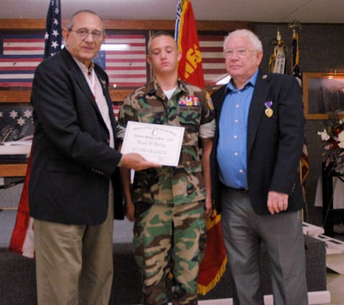 Young Marine Enoch Colley, center, earned an award for saving a man's life who'd been injured in a car accident. He also assisted first responders in freeing a woman and child from an overturned vehicle. The award was presented June 18 at the Elks Lodge in Crestview.