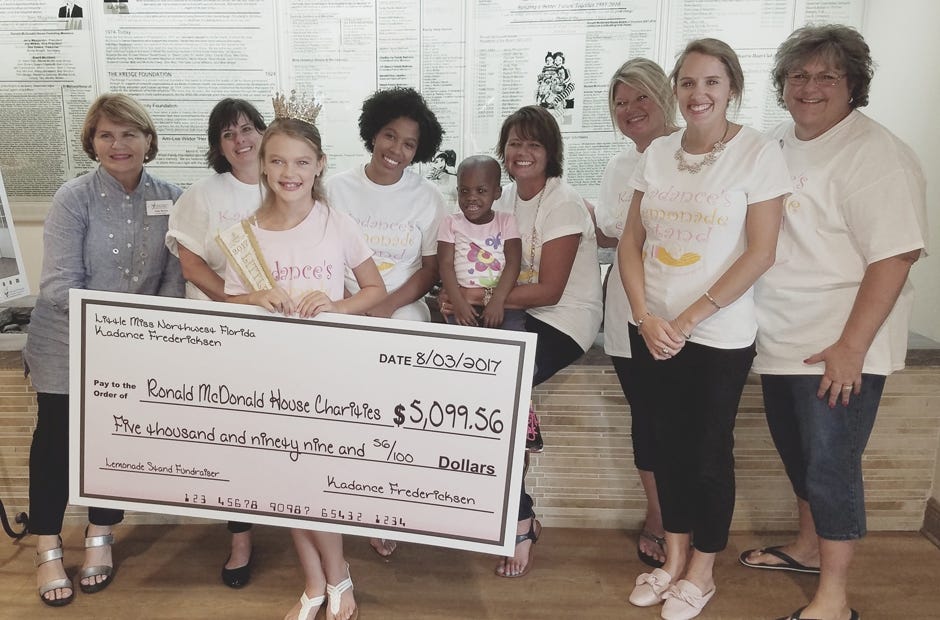 Crestview resident Kadance Fredericksen presents a check for more than $5,000 to Ronald McDonald House officials Aug. 3 in Pensacola. She ran a lemonade stand and T-shirt fundraiser to beat her goal of $1,500. [Special to the News Bulletin]