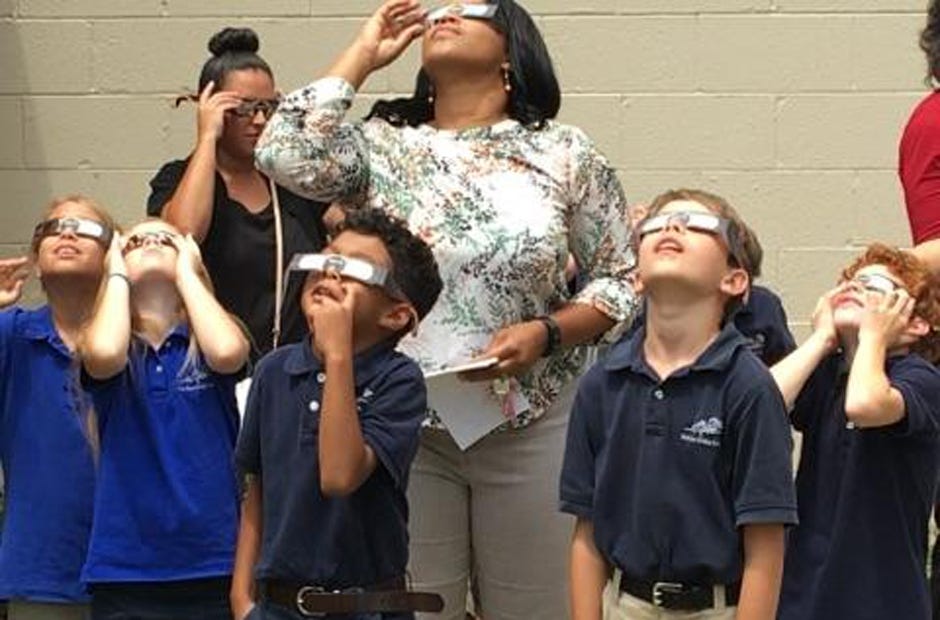 Tawiana Jenkins and some of her third grade students observe the solar eclipse Aug. 21 at the Rocky Bayou Christian School's Crestview campus. [Special to the News Bulletin]