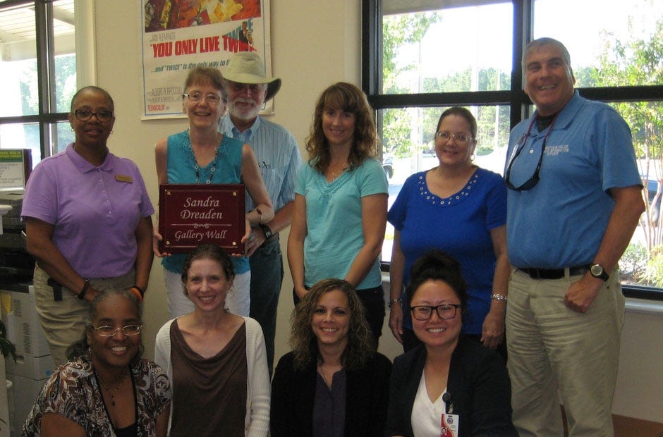 A group of friends, colleagues and relatives gathered to present former reference librarian Sandra Dreaden with a plaque Aug. 25 at the Crestview Public Library. Back row: CPL Clerk Sharon Jones, Sandra Dreaden, her husband, Art Dreaden, CPL Cataloger Sandy Nearbin and local arts enthusiast Brian Hughes. Front row: CPL Record Clerk Rita Florence, CPL Youth librarian Heather Nitzel, CPL Clerk Melissa Mercer, and CPL Director Marie Heath. [Special to the News Bulletin]