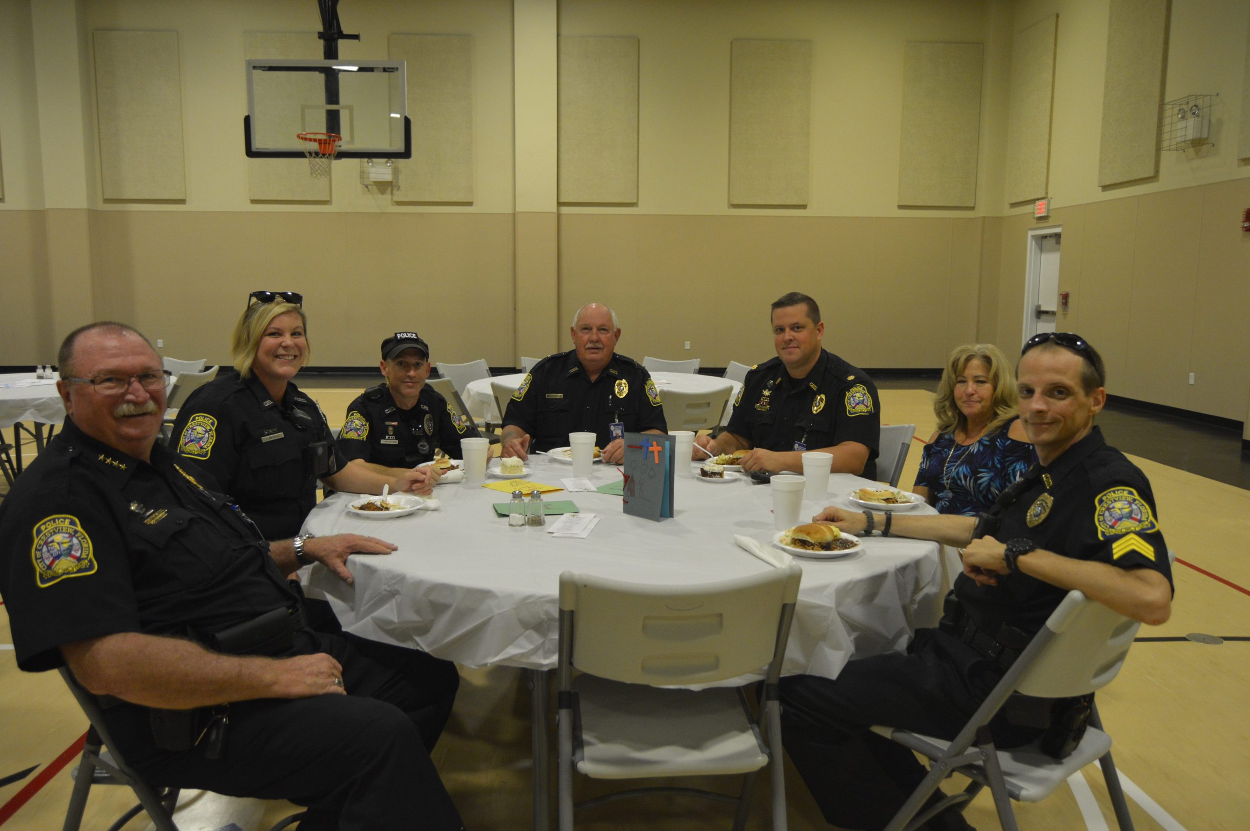 Crestview Police Chief Tony Taylor, Christine Lawrence, Corey Newcomer, Rick Brown, Andrew Schneider, Kathy Duke and Lucas Kraus enjoy the food offered for them at the Woodlawn Baptist Church first responder appreciation luncheon. [ALICIA ADAMS | News Bulletin]