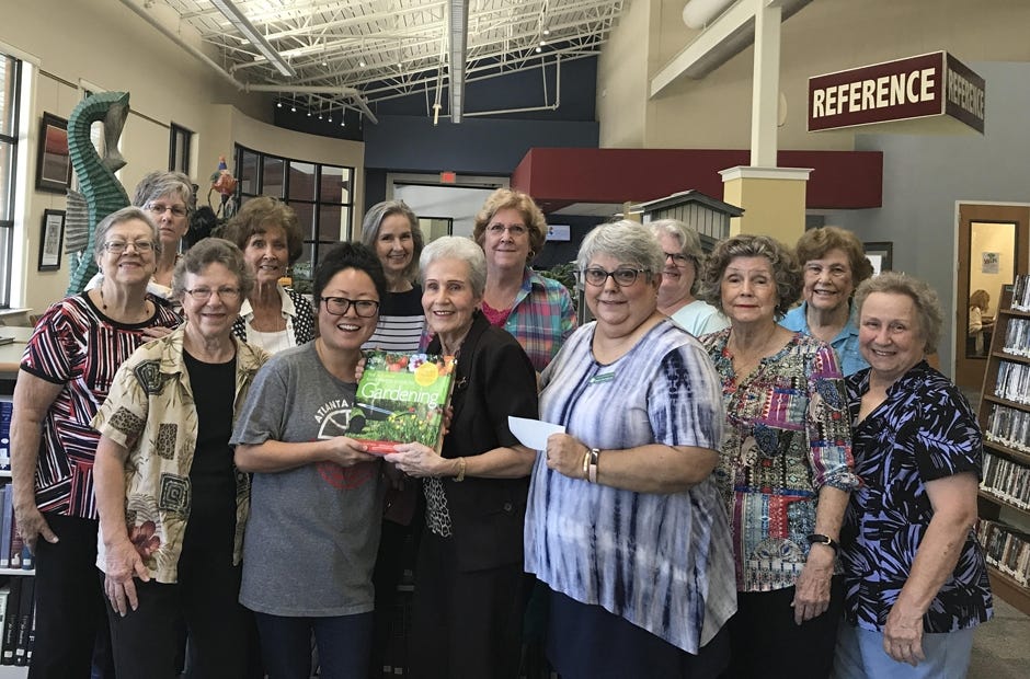 Dogwood Garden Club members presented a book on gardening and a monetary donation recently to the Crestview Public Library. The book is dedicated to the club's Woman of the Year, Thelma Smith. Front row, from left: Sarah Petty, Library Director Marie Heath, Ruth Herington, Thelma Smith, Beach Campbell and Mary Alberts. Back row: Teri McLeod, Thea Duhaime, Judy Rice, Celia Broadhead, Pam Callahan, Jane McCreary and Eva Fountain. [SPECIAL TO THE NEWS BULLETIN]