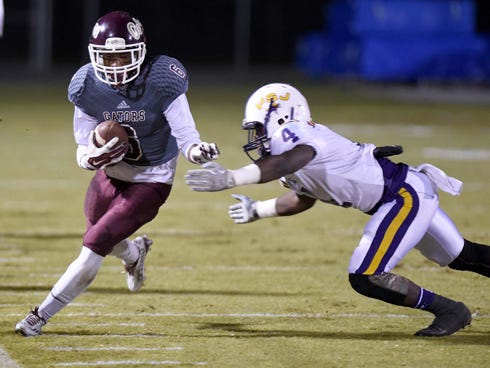 Baker School's Jamaal Day runs for yardage against Port St. Joe's Jasmin Thomas.