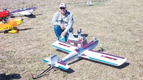 Tony Dunavant shows off his remote controlled airplane during a Laurel Hill RC Flyers gathering in 2014. The club dissolved shortly after, and Larry Pitts is restablishing the organization. [File photo]