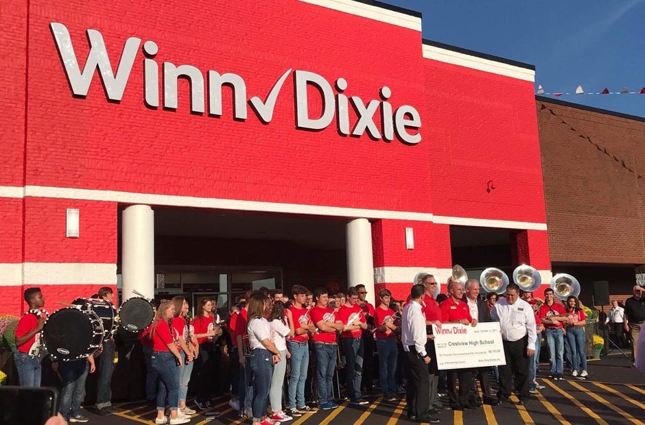Crestview High School's band, The Big Red Machine, accepts a check for more than $6,000 from Winn-Dixie Oct. 12 in Crestview. [LYNSEY REEVES | SPECIAL TO THE NEWS BULLETIN]