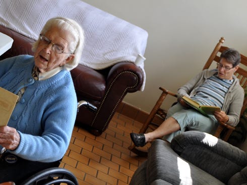 Crestview Manor residents, from left, Imogene Davis and Cathy Cochran, sing praise music with Woodlawn Baptist Church members.