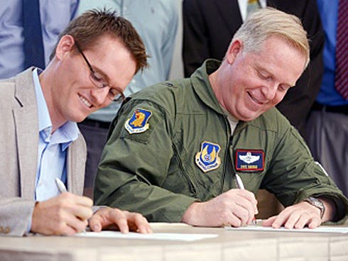 Okaloosa County Commisioner Nathan Boyles, left, and Air Force Gen. Dave Harris sign a series of agreements between Eglin and the county as part of the Air Force’s Community Partnership Program.