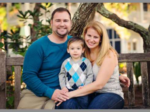 Joseph Deslauriers and his wife, Lisa, embrace their son Cameron, now 2, in a family photo. U.S. Gold Gymnastics and Cheerleading in Crestview seeks the community's support in raising funds for the wounded soldier and his family, who are building a Destin home.
